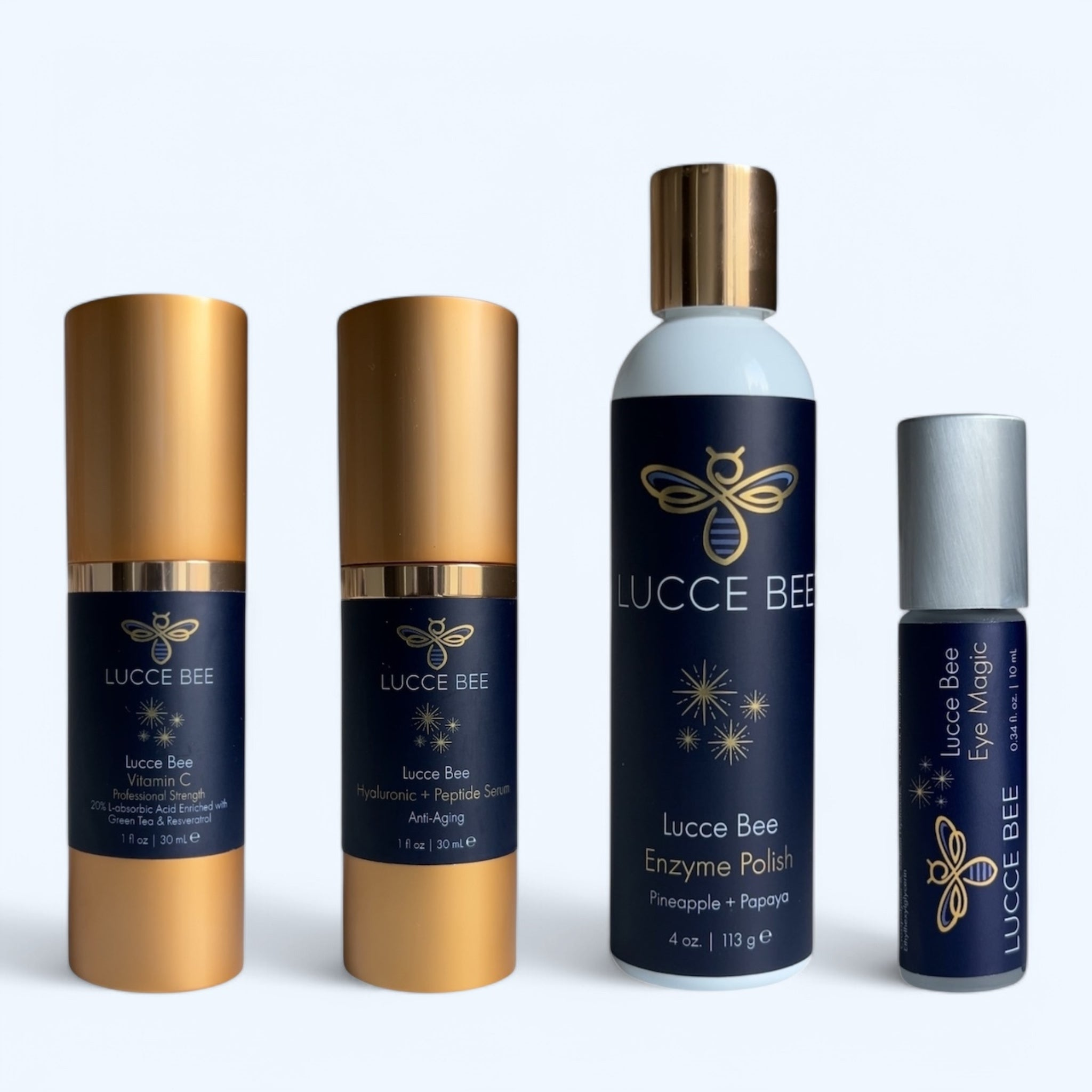 Lucce Bee skincare products featuring Vitamin C Serum, Hyaluronic + Peptide Serum, Enzyme Polish with pineapple and papaya, and Eye Magic. Clinical luxury skincare essentials for brightening, anti-aging, hydration, exfoliation, and under-eye care.
