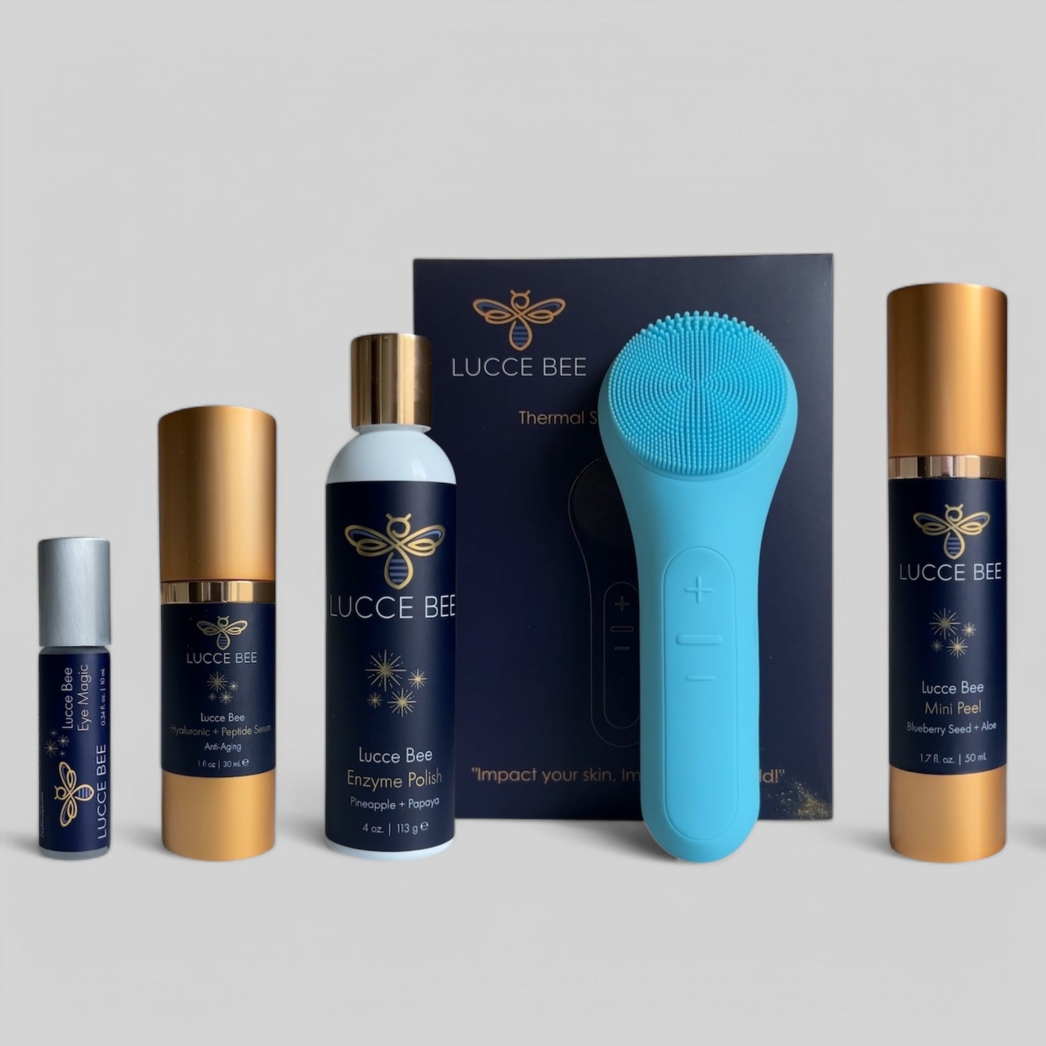 Lucce Bee complete skincare set featuring Eye Magic roller, Hyaluronic + Peptide Serum, Enzyme Polish, Mini Peel, and blue Thermal Sonic Facial Brush for luxury facial care and glowing skin