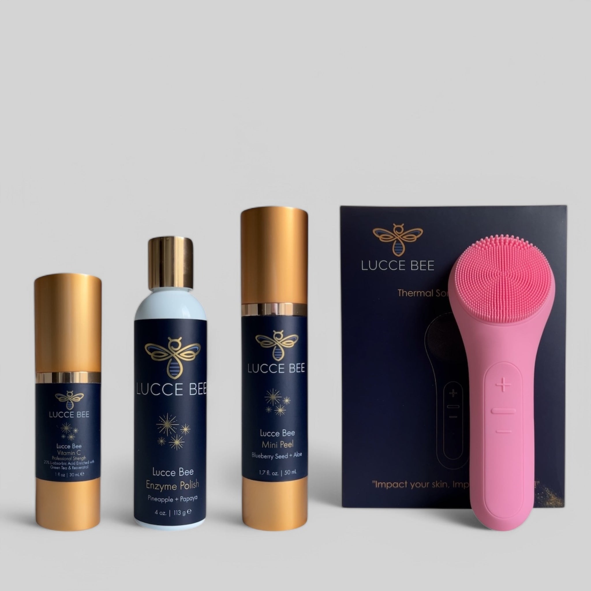 Lucce Bee complete skincare set with Vitamin C Serum, Enzyme Polish, Mini Peel, and pink Thermal Sonic Facial Brush for radiant, smooth, and rejuvenated skin