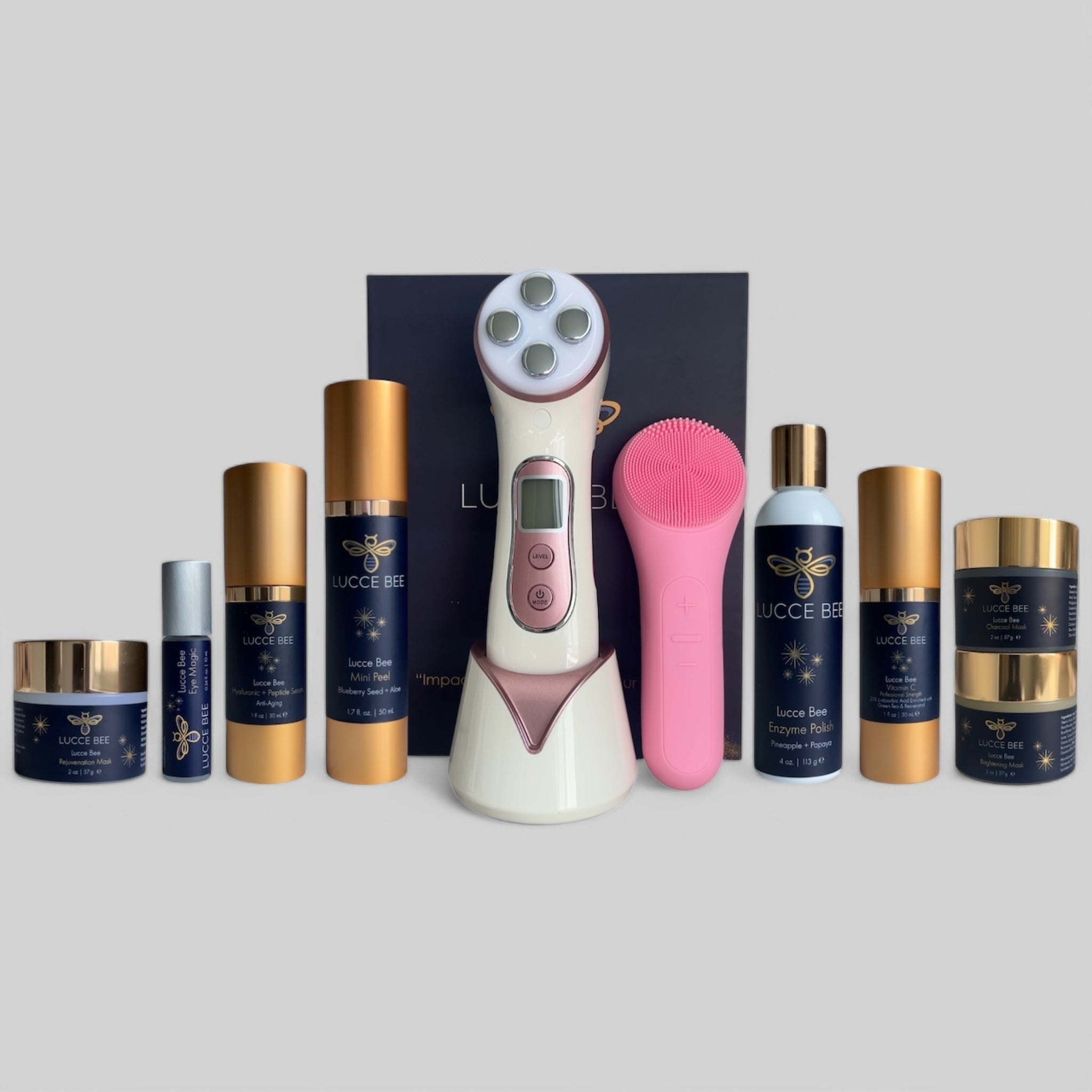 Complete Lucce Bee luxury skincare collection featuring masks, serums, eye treatment, Enzyme Polish, Mini Peel, and advanced facial tools including pink Thermal Sonic Brush and LED therapy device for radiant, youthful skin