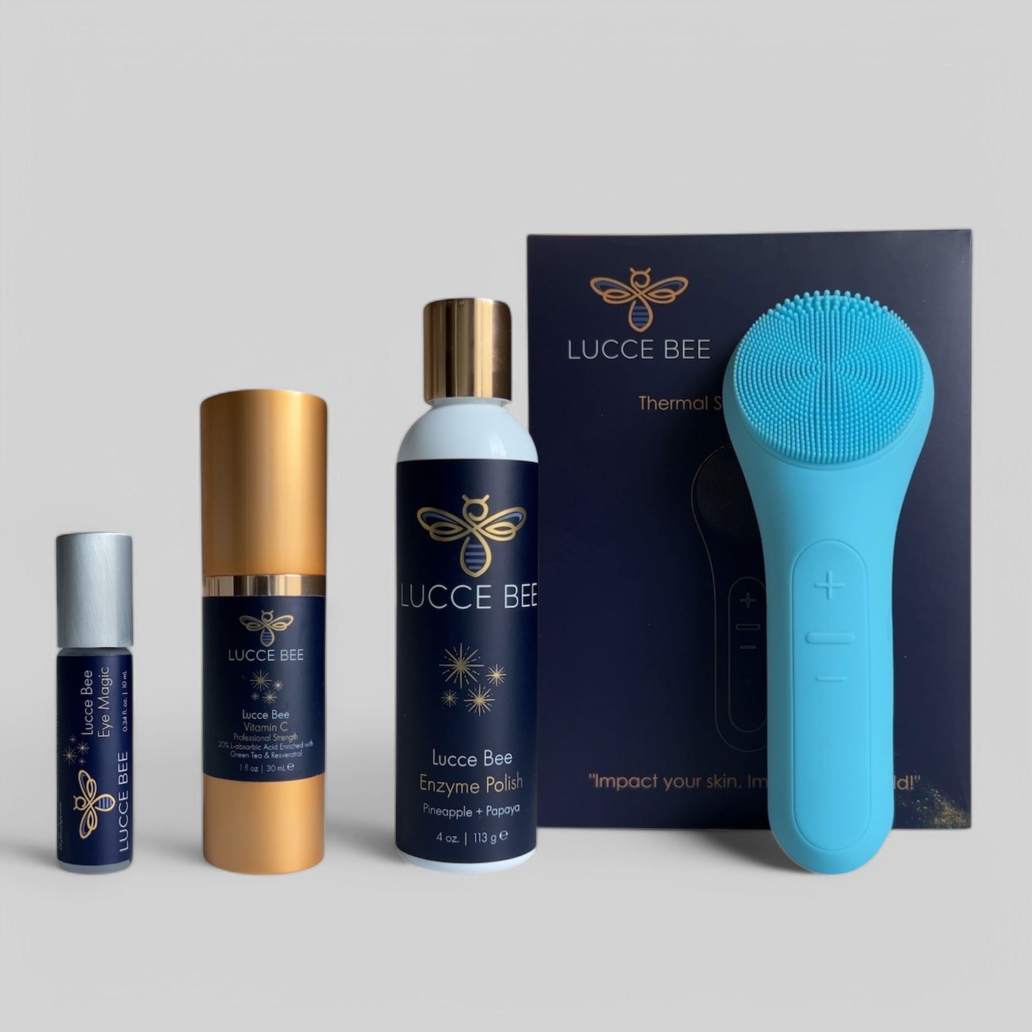 Lucce Bee skincare set with Eye Magic roller, Vitamin C Serum, Enzyme Polish with Pineapple + Papaya, and blue Thermal Sonic Facial Brush for radiant, youthful skin