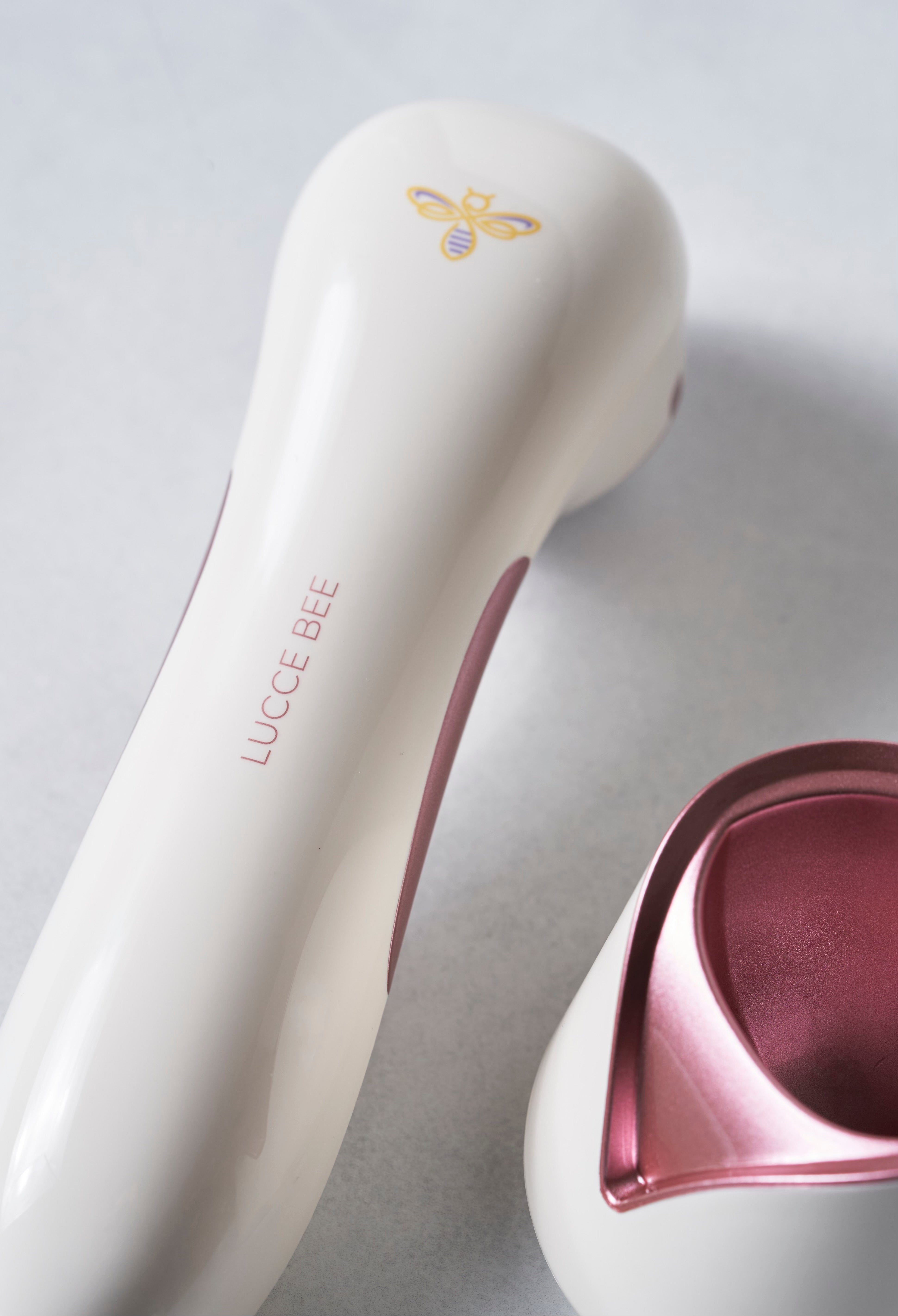 Close-Up of Lucce Bee Skincare Device – Elegant Handheld Anti-Aging Tool with Rose Gold Accents and Sleek Ergonomic Design