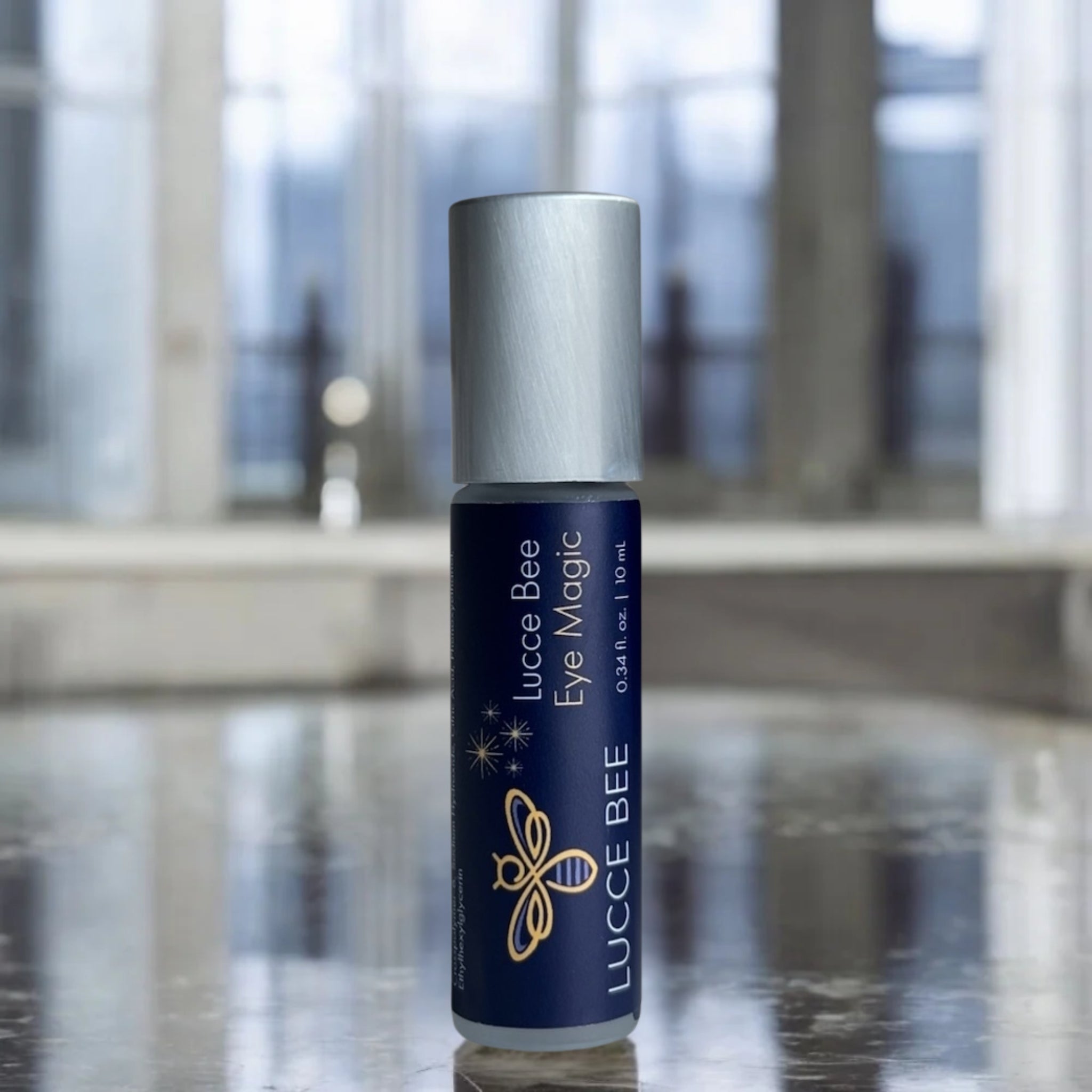 Lucce Bee Eye Magic – Revitalizing Eye Serum with Cooling Roller, Displayed on Marble Counter for Puffiness and Dark Circle Relief (10 ml)